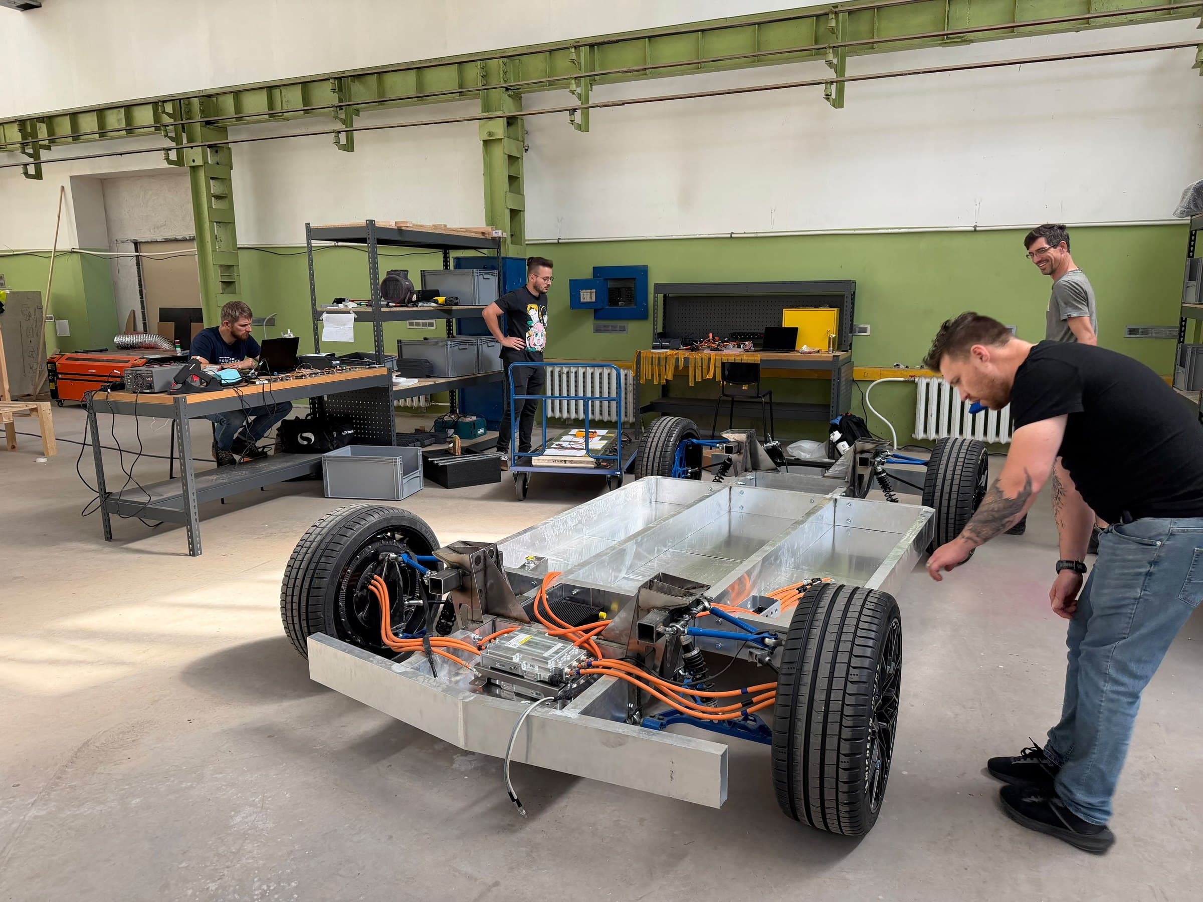 Engineers building an electric vehicle chassis in the Oven